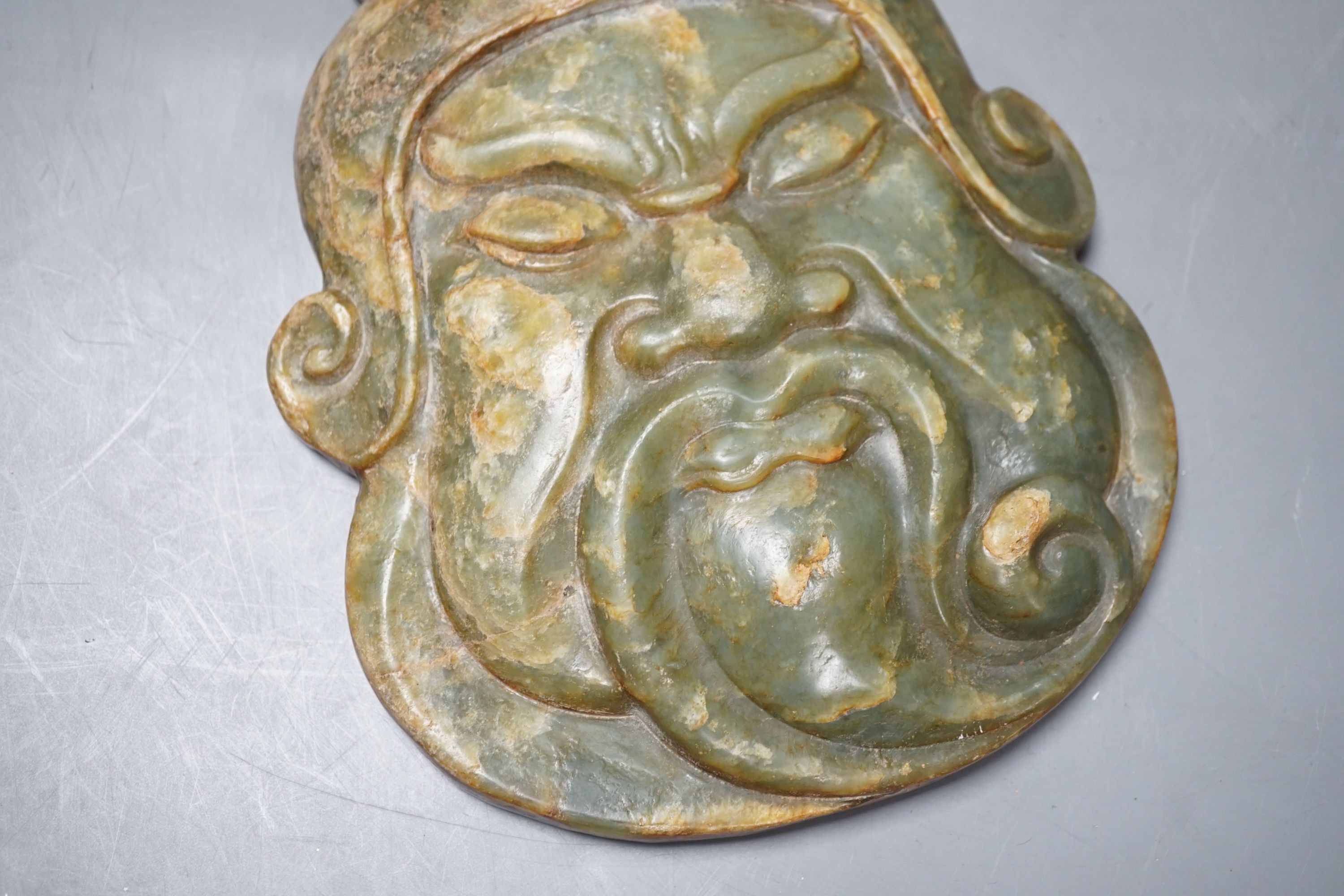 A green hard stone mask carving, height 21cms